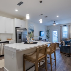 Bright modern kitchen with stainless-steel appliances at Madison Midtown, luxury apartments for rent in Melbourne FL.